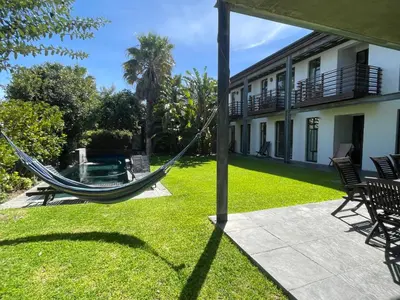a hammock in the yard of a house at Sunset-Loft in Cape Town