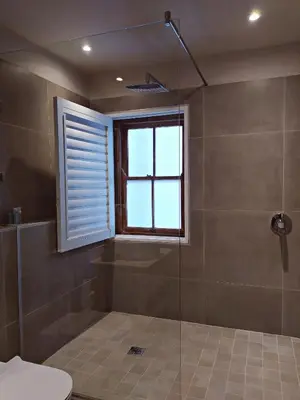 a bathroom with a shower with a window at Apartment at Hermanus Waterfront in Hermanus