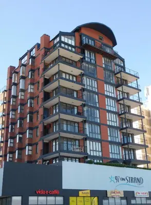 a tall apartment building in front of a building at 97 On Strand in Strand