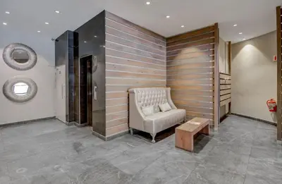 a living room with a chair and a table at 97 On Strand in Strand