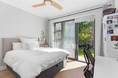 a bedroom with a bed and a large window at Sunset Villa 50 in Cape Town