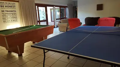 a living room with a ping pong table at Mafari Beach House in Hermanus
