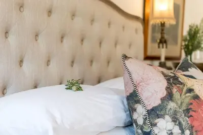 a bedroom with a white bed with a pillow at Serendipite Villa in Franschhoek