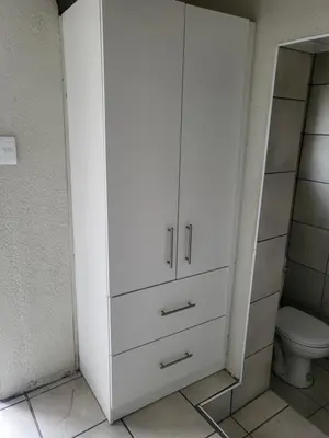 a bathroom with a white cabinet and a toilet at 9 on Oostersee in Cape Town