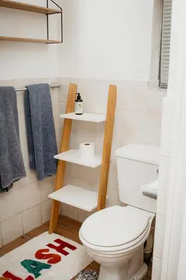 a bathroom with a toilet and a towel rack at Mooi Uitsig Lodge in Paarl