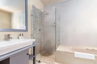 a bathroom with a sink and a shower at La Terra de Luc in Franschhoek