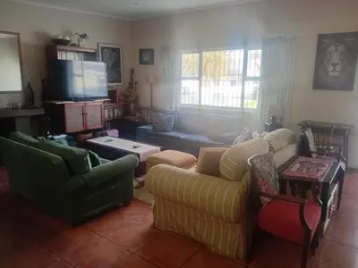 a living room with two couches and a tv at Out of Africa in Sandbaai, Hermanus in Hermanus