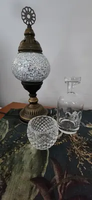 a table with a lamp and a glass vase at Audrey's Self-Catering Accommodation in Cape Town
