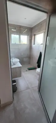 a bathroom with a shower and a sink and a toilet at Audrey's Self-Catering Accommodation in Cape Town