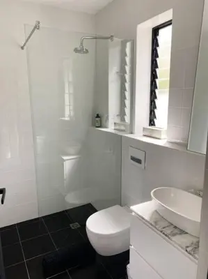 a white bathroom with a toilet and a sink at Stellenbosch - Winelands Living Solar in Stellenbosch