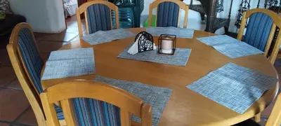 a wooden table topped with napkins and a candle at The 10th Hole - Golf Estate in Villiersdorp