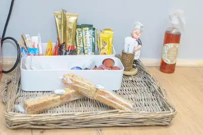a wicker basket with a container of items on a table at Royal Pearl, Insta-worthy APT in Paarl