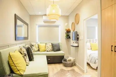 a living room with a couch and a bed at Royal Pearl, Insta-worthy APT in Paarl