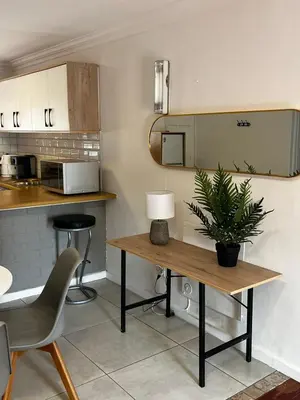 a kitchen with a table with a plant on it at Lagoon Lodge in Cape Town
