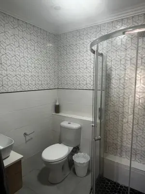 a bathroom with a toilet and a sink and a shower at Lagoon Lodge in Cape Town