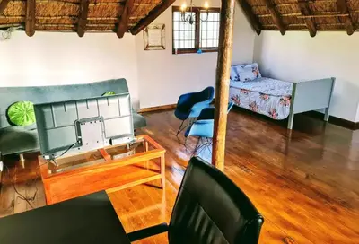 a living room with a sewing machine on a table at Mead, Pinelands in Cape Town