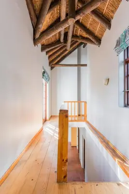 an empty room with wooden floors and a wooden ceiling at Mead, Pinelands in Cape Town