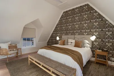 a bedroom with a large bed with a wall at Mount Vernon Manor in Klapmuts