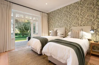 a bedroom with two beds and a window at Mount Vernon Manor in Klapmuts