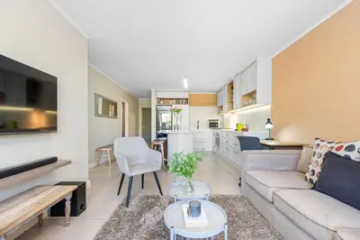 a living room with a couch and a table at Mayfair Luxury 212 by Host Agents in Cape Town