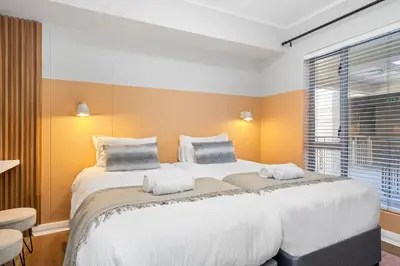 a large white bed in a room with a window at Mayfair Luxury 212 by Host Agents in Cape Town