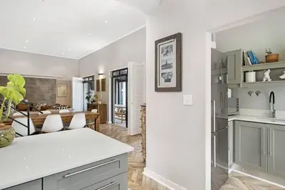 a kitchen and living room with a white counter top at Sunset Links Villa 54 in Cape Town