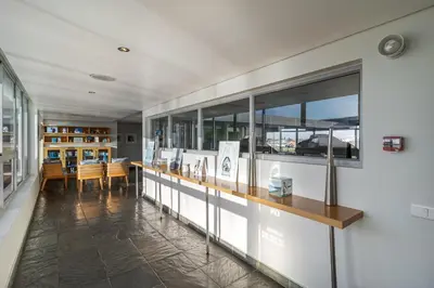 a room with a long counter with a table at Luxury Beach Escape Sleeps 4 - Ocean View - Spa - Pool - Gym - Back Up Power in Cape Town