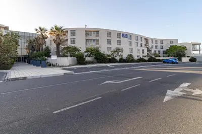an empty street in front of a building at Luxury Beach Escape Sleeps 4 - Ocean View - Spa - Pool - Gym - Back Up Power in Cape Town