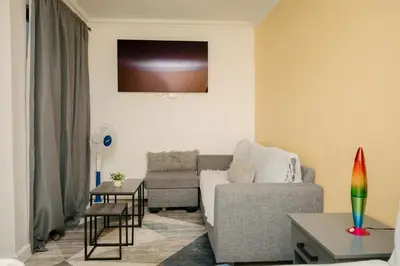 a living room with a couch and a table at BOSTON HOUSE in Cape Town