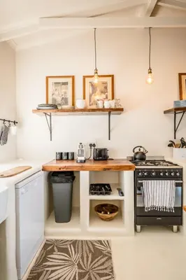 a small kitchen with a stove and a counter at Klein Paradys in Kleinmond
