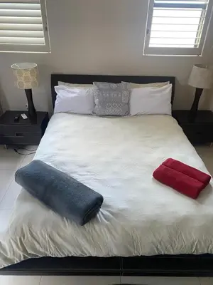 a bed with two pillows on top of it at Big room in Stellenbosch in Stellenbosch