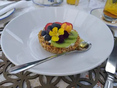a dessert on a white plate with a spoon at L'Auberge Chanteclair in Franschhoek
