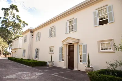 a large white house with a driveway at Morton Manor in Somerset West