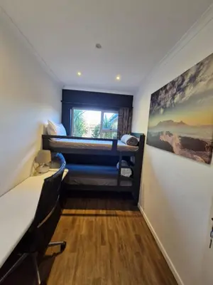 a room with two bunk beds and a window at Spacious home in Cape Towns Blouberg area in Cape Town