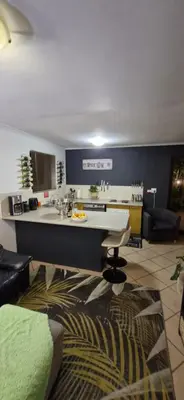 a living room with a kitchen and a counter top at Apartment with garden in Cape Town
