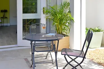a table and two chairs in front of a house at Fransvliet Guest House in Franschhoek