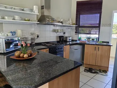 a kitchen with a bowl of fruit on a counter at Nautica Strand in Cape Town