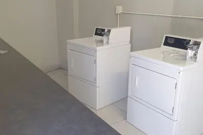 a room with two washer and dryers in a room at Rondebosch Central in Cape Town