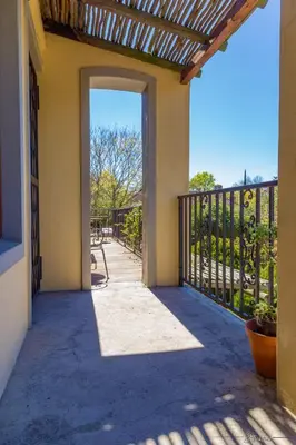an open door to a patio with a fence at 10 Alexander B&B in Stellenbosch