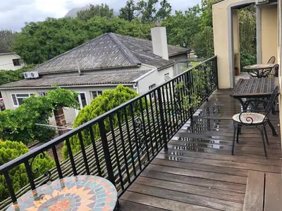 a balcony with a table and chairs on a house at 10 Alexander B&B in Stellenbosch