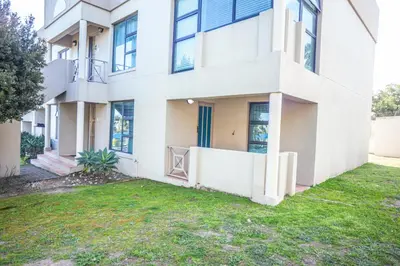 a white building with a yard in front of it at @Villa de Vie holiday apartment in Cape Town