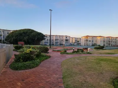 a brick walkway in front of a building at Hermanus Beach Club UNIT 74 in Hermanus