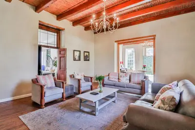a living room with couches and a table at Twistniet BnB in Wellington