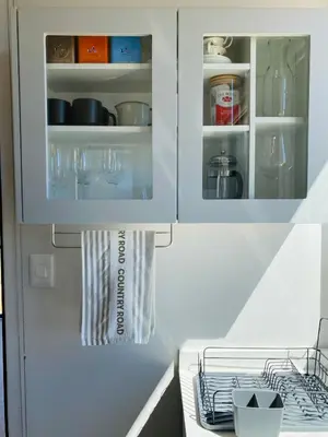 a kitchen with white cabinets and a counter top at Sneeukop Mountain Cottage in Paarl
