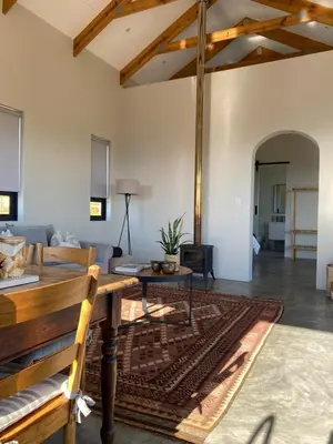 a living room with a couch and a table at Sneeukop Mountain Cottage in Paarl