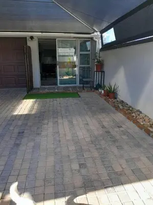 a front porch of a house with a patio at Magnolia Cottage in Cape Town