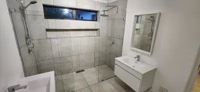 a bathroom with a shower and a toilet and a sink at Jock's Bay View in Bettyʼs Bay