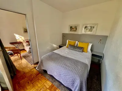 a bedroom with a bed with yellow pillows at #Restyourcase in Stellenbosch