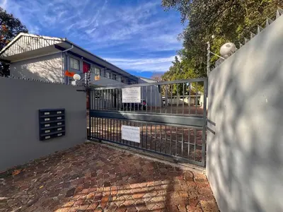a fence with a gate in front of a house at #Restyourcase in Stellenbosch