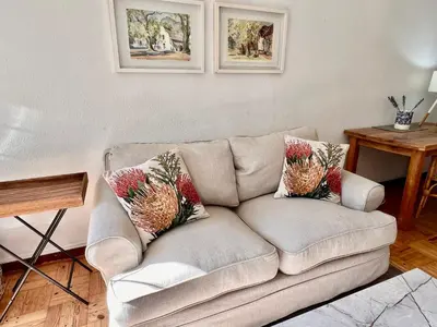 a living room with a couch with pillows on it at #Restyourcase in Stellenbosch